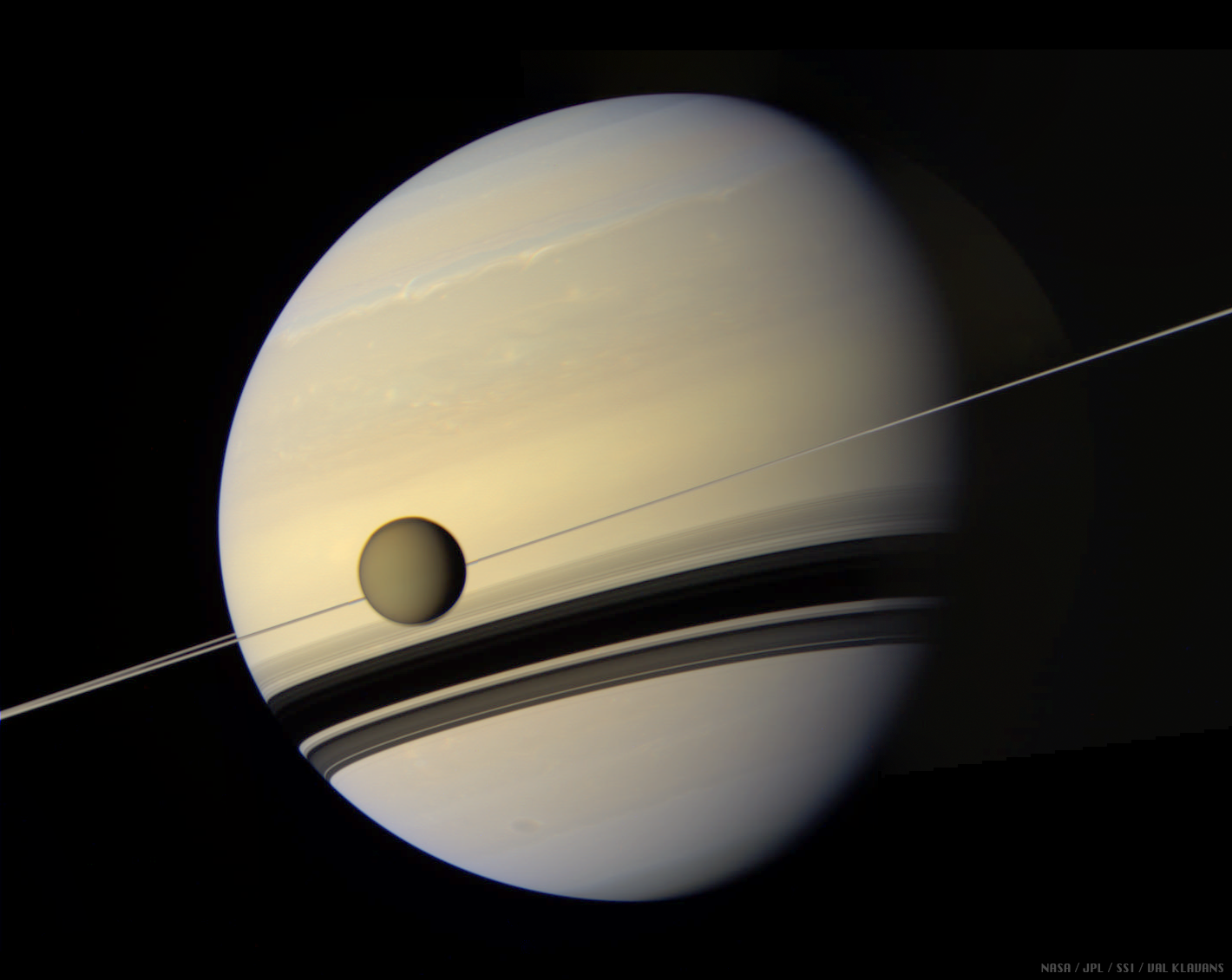 Titan crossing Saturn, with the rings nearly edge-on, imaged by Cassini